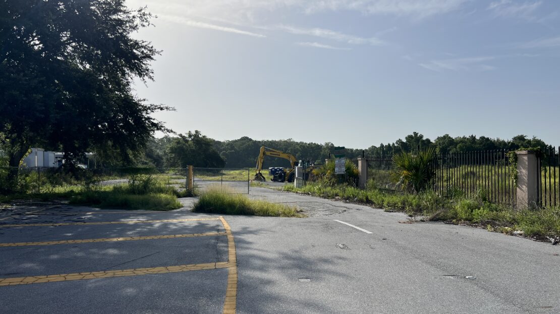 Excavator staged at the former Flea World site in Sanford FL ahead of the Reagan Center redevelopment