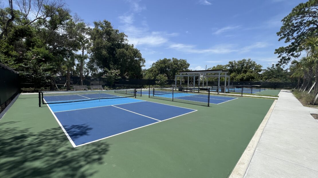 Wide view of Lake Mary pickleball courts with pavilion in background