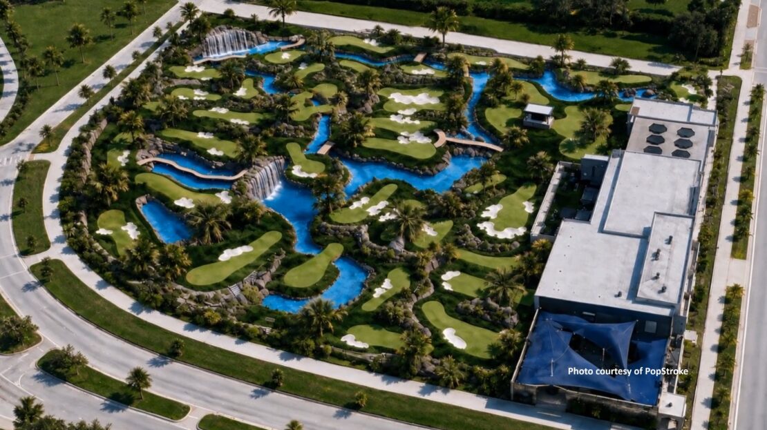 Aerial view of PopStroke's two 18-hole mini golf courses in Orlando with a flowing river, waterfalls, and palm trees.