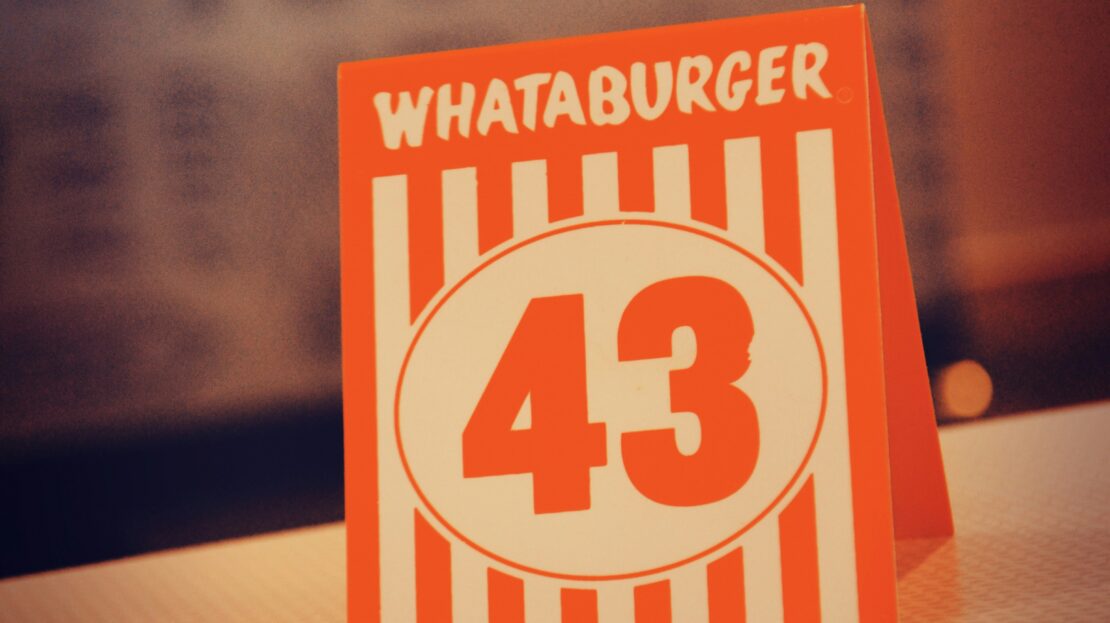 Classic Whataburger table number card with retro striped branding, representing the chain's return to Orlando